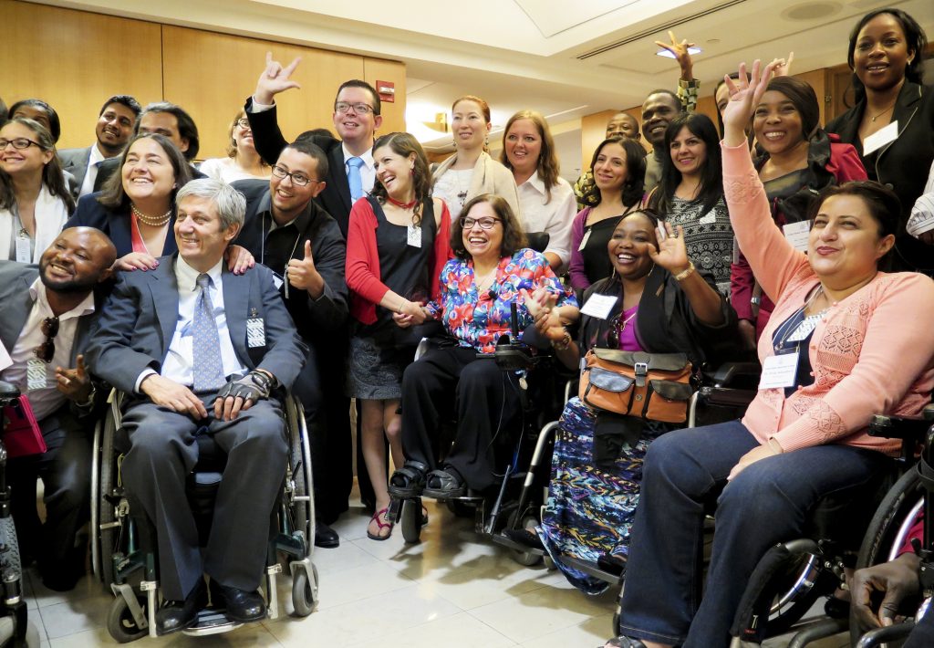 Judith Heumann surrounded by people